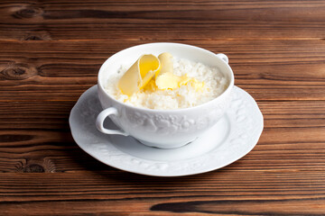 rice porridge with butter on a wooden background