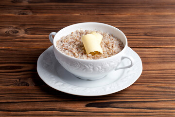 buckwheat porridge with butter on a wooden background