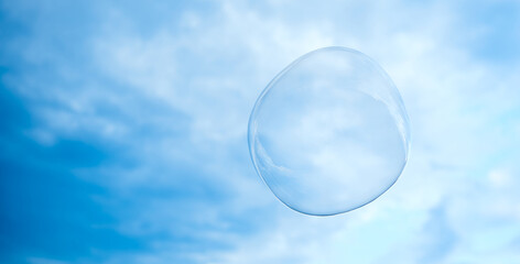 big soap bubble. The sky is light cloudy.