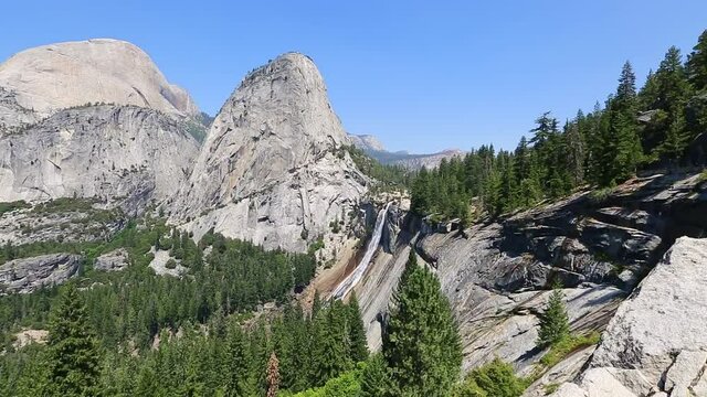 Panorama of Half Dome, Mt Broderick, and Liberty Cap with Nevada Fall waterfall on Merced River from Mist Trail in Yosemite National Park. Summer travel holidays in California, United States.