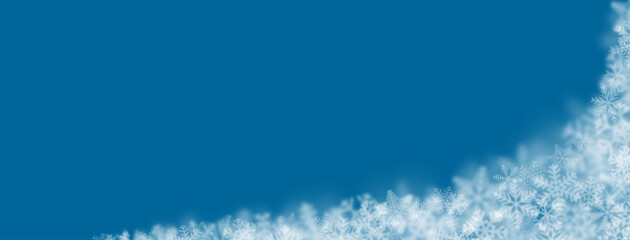 Christmas background of snowflakes of different shapes, sizes, blur and transparency on blue background