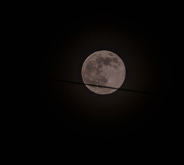 June full moon surrounded by a halo caused by gases in the atmosphere taken in South Korea.