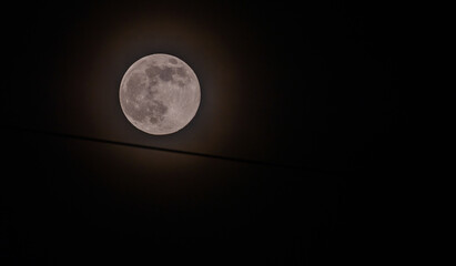 Naklejka na ściany i meble June full moon surrounded by a halo