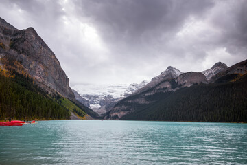 Lake Louise with canoes and cold dark clouds