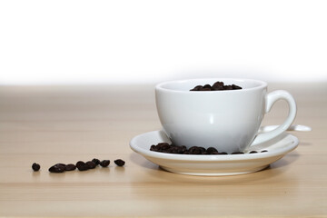 Coffee beans with coffee cup on wooden board