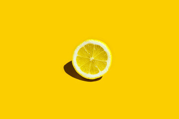 Lemons fruits. Juicy slice of lemon on yellow background