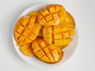  Many Sliced mango fruit on plate. Top view.