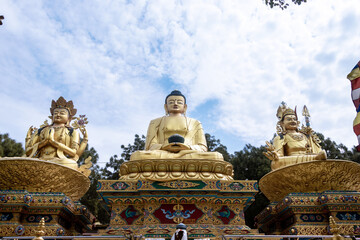 Fototapeta na wymiar The Golden Buddha Statues in Buddha park, Swayambhunath area, Kathmandu, Nepal, the World Heritage Site declared by UNESCO