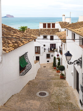 Steps in narrow street with view over the ocean and the rock of Calpe in the old town of Altea, Costa Blanca, Spain