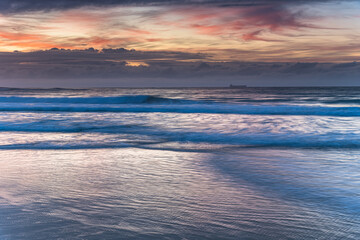 Fototapeta na wymiar Sunrise Seascape with Clouds and Ships on the Horizon