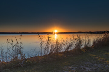 Sunset over the Lake with Clear Skies and Sun