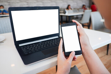 Cropped shot view of woman’s Hands hold the smartphone with blank copy space screen for your information content or text message on the gray granite at the modern place.