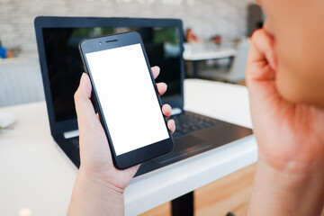 Cropped shot view of woman’s Hands hold the smartphone with blank copy space screen for your information content or text message on the gray granite at the modern place.