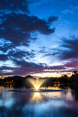 Naklejka na ściany i meble Sunset over the lake and the fountain