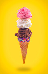 An Ice Cream Cone with Strawberry Vanilla and Chocolate in a Pointed Sugar Cone Floating in the Air