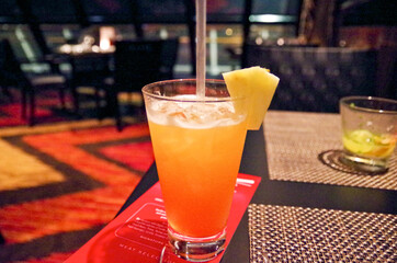 Cocktail on table in speciality restaurant for steaks or steak house with elegant set formal tables...