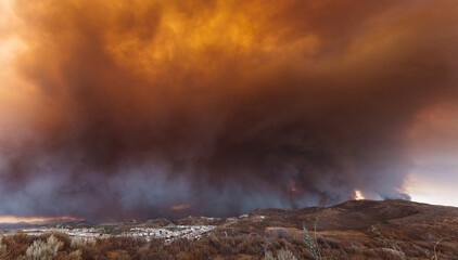 California wildfire burning out of control and threatening a residential area