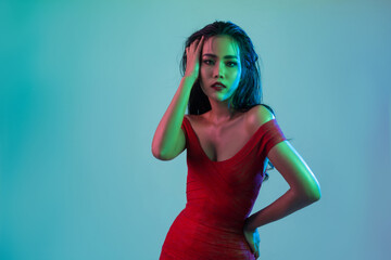 Asian woman wearing red clothes having fun at a party. With colorful lights