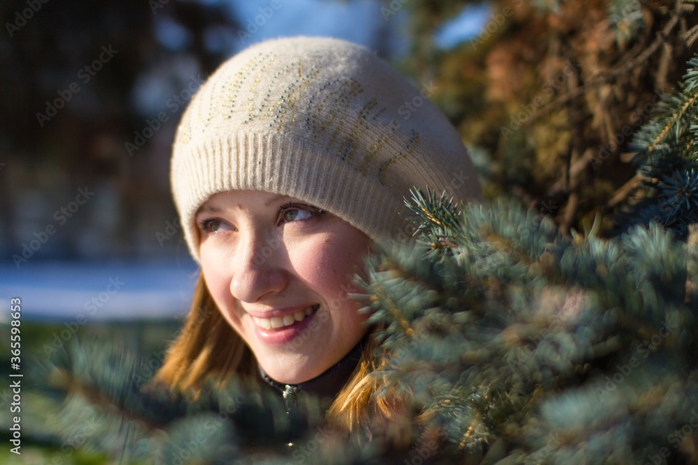 Wall mural Beautiful young blonde girl in winter.