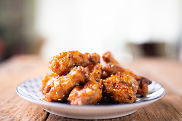 Sour-sweet baked chicken wings sesame and  teriyaki sauce.