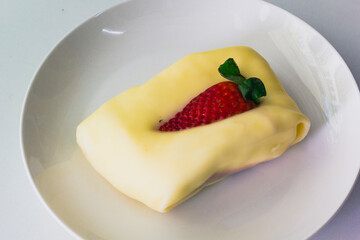 Cream Crepe cake top up with strawberry