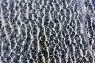 Beautiful abstract frozen gray ripples of water of Lake Baikal