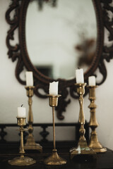 Antiques. Old candles and a mirror. Beautiful interior in the apartment
