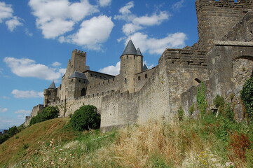 Fototapeta na wymiar Carcassonne castle side view, Carcassonne Provence, France, side view of the castle from the side of the hill in a sunny day in Provence. Middle age castle UNESCO.