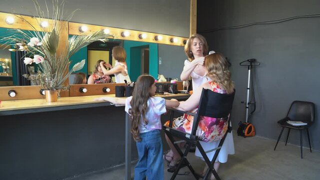dressing room in Studio. daughter while waiting for mom do makeup and styling.