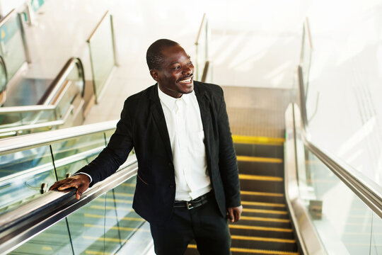 african man on an escalator