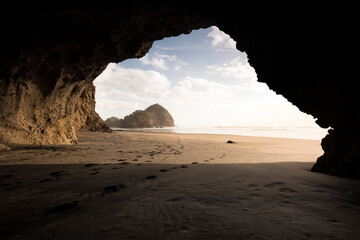 cave on bethells beach, new zealand