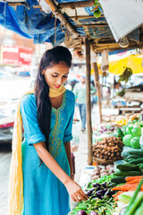 Pretty Indian woman in the organic farm market 