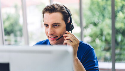 Happy call center smiling businessman operator customer support consult phone services agen working with wireless headset microphone and computer at call center office