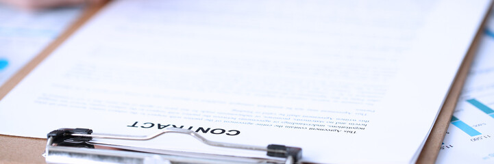 Obraz premium Male arm in suit and tie fill form clipped pad with silver pen closeup. Sign gesture read pact sale agent bank job make note loan credit mortgage investment finance executive chief legal teamwork law