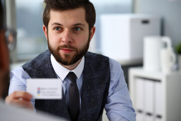 Male arm in suit give blank calling card to visitor portrait. White collar colleagues company name exchange job interview sale clerk id executive or ceo finance support formal identity etiquette