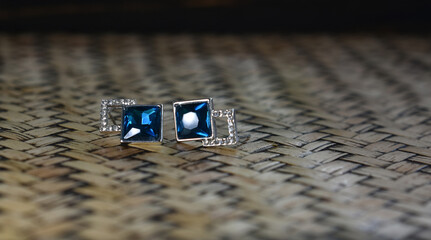White gold earrings decorated with blue sapphire