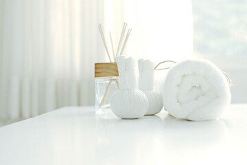 Fototapeta na wymiar Spa concept with rolled white towels placed on a white table.