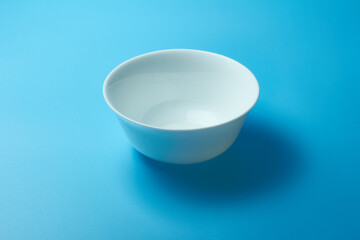A perfectly white plate on a blue background