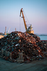 Garbage pile in trash dump or junkyard, metal crane garbage consumption junkyard scarp, Global warming, Ecosystem and environment concepts and background.
