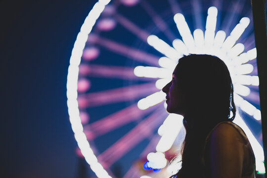 HAPPY GIRL DREAMING INFRONT OF A FERRIS WHEEL
