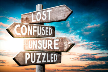 Lost, confused, unsure, puzzled - wooden signpost, roadsign with four arrows