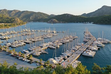 Yacht Marina. Footage of  many luxury boats and yachts in the harbor. Beautiful forested mountain landscape with the sea in the background. Orhaniye, Hisaronu, Marmaris - TURKEY