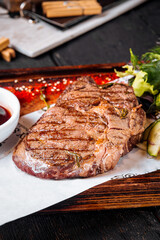 Grilled juicy steak sauce salad on wooden board