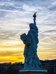 Famous Statue de la Liberte against the sunset during a bright day of February with dramatic sky - Paris, France. This statue was given in 1889 to France by U.S. citizens living in Paris.