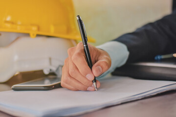 Hand holding pen signature on document (concept business,finance,insurance)