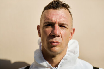 Fatigued sanitation worker after finishing a disinfection of contaminated areas.