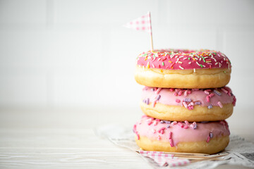 a stack of three donuts in glaze