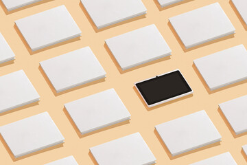 White books and an electronic tablet in the middle, pattern on a yellow background. The concept of reading, the replacement of technology.