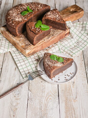 Chocolate brownie. Homemade chocolate cake on a wooden cutting board. Cooking delicious desserts at home. Vertical shot