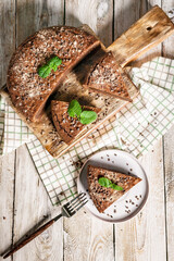 Homemade chocolate cake brownie on a wooden cutting board. Cooking delicious desserts at home. Vertical shot